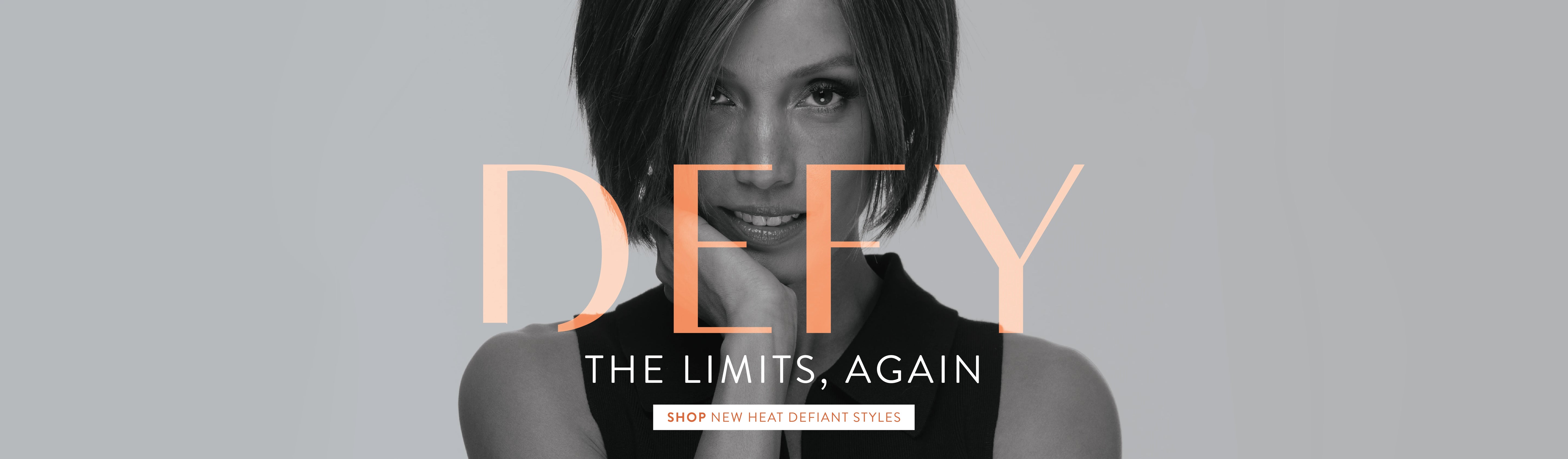 Woman with short hair against a gray background with 'DEFY' text.